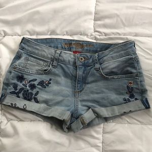 Light wash embroidered jean shorts.